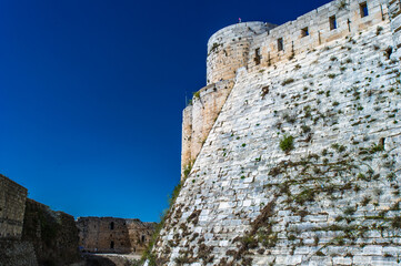It's Part of the Krak des Chevaliers, a Crusader castle in Syria and one of the most important preserved medieval castles in the world. - obrazy, fototapety, plakaty