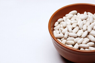 Beans in bowl, Close Up against white background.