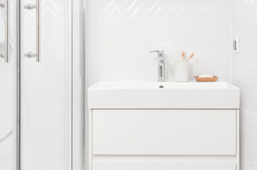 Sink basin faucet close-up in modern design of bathroom interior