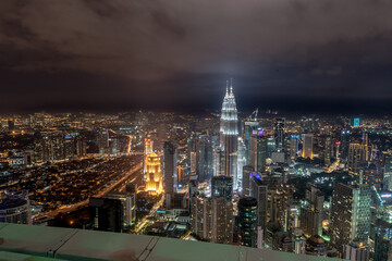 Fototapeta na wymiar Kuala Lumpur, Federal Territory / Malaysia - February 25, 2017: Aerial view of KLCC and Kuala Lumpur with buildings lights on in evening.