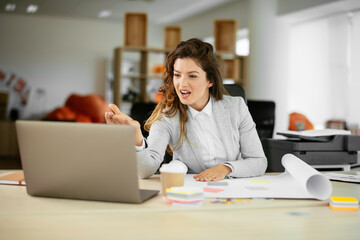 Beautiful young businesswoman working on project. Businesswoman in suit working in office.	