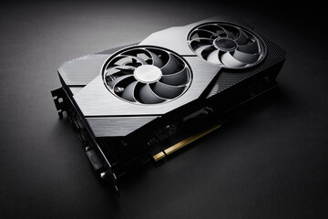 modern black computer video card on a black background, deep shadows and contrasting light, one...