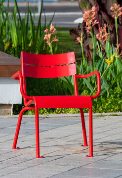 Red Metal Chair In A City Park