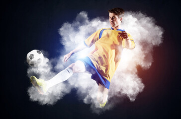 Soccer player kicking ball in white smoke
