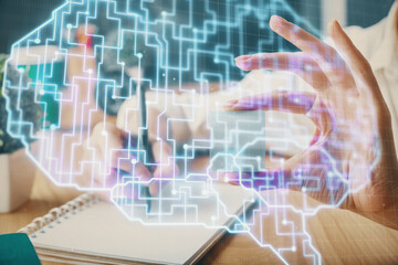 Multi exposure of writing hand on background with brain hologram. Concept of learning.