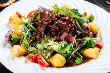Warm salad in ginger sauce with beef and potatoes