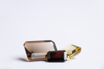 faceted precious stones of various shapes and sizes on a white background topaz aquamarine...