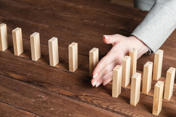 Business woman block domino effect.