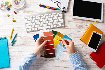 Interior designer choosing colors from swatches