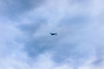 Blue sky and airplane through the clouds