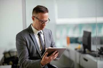 Handsome businessman working in office. Young man preparing for the meeting.	