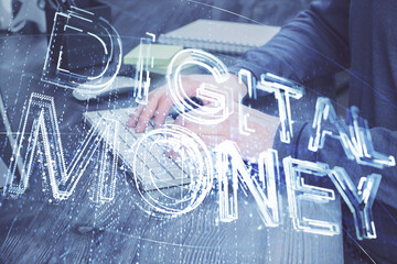 Crypto currency theme hologram with businessman working on computer on background. Concept of...