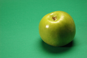 Red Apple on green background