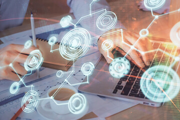 Media network theme hologram with man working on computer on background. Concept of internet...