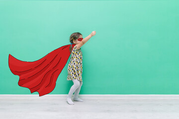 Girl power. Child in the form of a superhero. Hand-drawn raincoat and mask. Funny little girl on a...