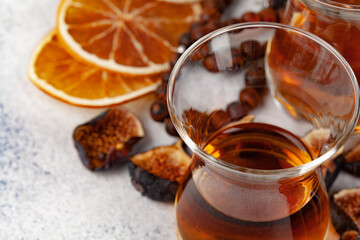 Cup of tea decorated with pieces of dried orange and fig