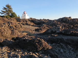 Fototapeta na wymiar a lighthouse at the Wild Pacific Trail in Ucluelet on Vancouver Island in the province British Columbia in the month of December, Canada