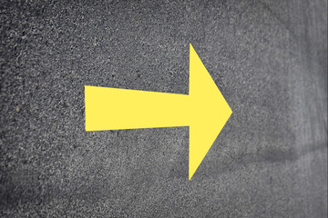 Yellow arrow on road surface, Business challenge concept and keep moving idea
