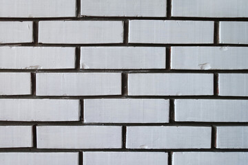 Old brick wall painted in white, close up. White bricks texture and background.