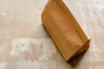 brown paper bag on weathered surface