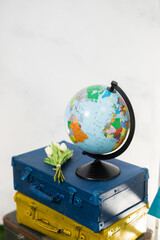 Travel or turism concept. Side view globe on vintage suitcases