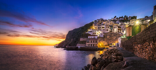 Panoramic view of La Caleta-Guardia little fishing port at dusk, Salobreña, Granada province,...