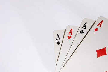 Poker cards with four A on white background .