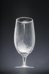 Empty glass on black background, copy space
