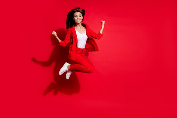 Full length photo of attractive lady worker having fun jumping high up good mood celebrate startup...
