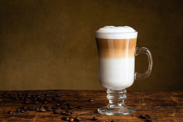 Cafe latte macchiato layered coffee in a see through glass irish coffee glass