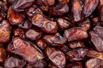 Dried dates background, sort khidri, vegan sweet superfood, topview