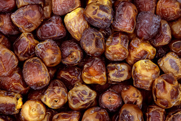 Dried dates background, sort sukkary or sukari, vegan sweet superfood, topview