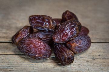 Dried dates on wooden table, sort medjool, sweet vegan superfruit