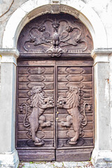 Carved decoration with two lions on an ancient wooden door