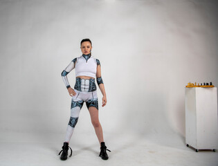beautiful brunette girl in a robot suit posing in various poses on a white background