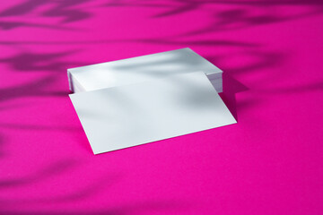 Advertising mock-up. White blank businesscards on bright pink background