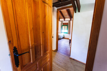 Corridor and bedroom inside an old-style rental cottage.