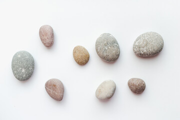 Fototapeta na wymiar sea stones on white background, smooth stones