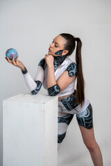 beautiful brunette girl in a robot suit plays various objects and ordinary games