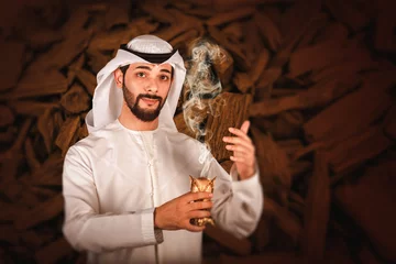 Fototapeten Arab man holding Bakhour holder celebrating the holy month of Ramadan Kareem, Arabic Bakhour advertising © Moez