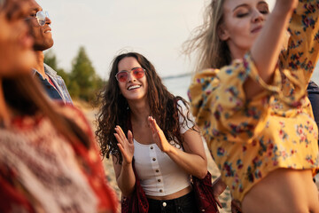 Group of young people dancing on the beach