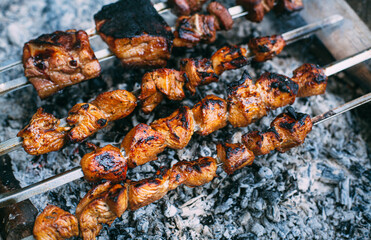 Skewers of pork ribs and chicken on skewers. Grilled meat. Cooking outdoors..
