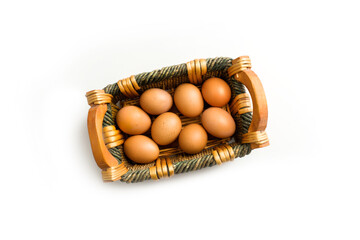 Basket with eggs on white background