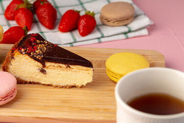 Piece of cheesecake with chocolate top and berries