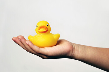 Hand holding a yellow Inflatable duck toy