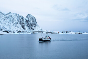 A traditional norwegian fishing boat returns to harbour. 