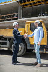 Fototapeta na wymiar Building supervisor and foreman greeting, shaking hands with each other