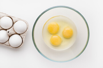egg yolk in a bowl, a raw egg, eggs on a white background