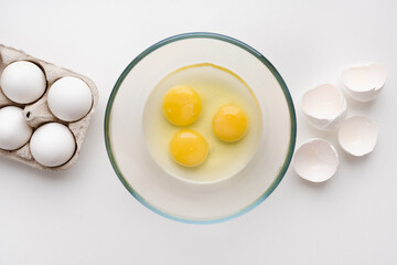 egg yolk in a bowl, a raw egg, eggs on a white background