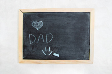 Dad and a heart for Happy Father's Day inscription at blackboard